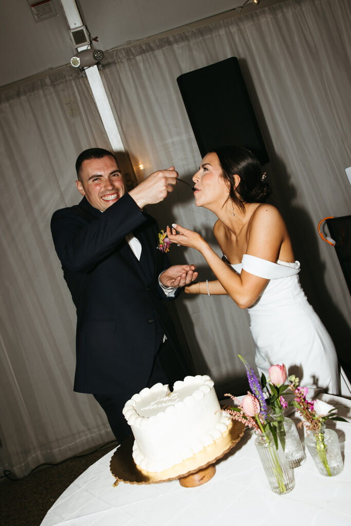 candid cake cutting photos at massachusetts wedding