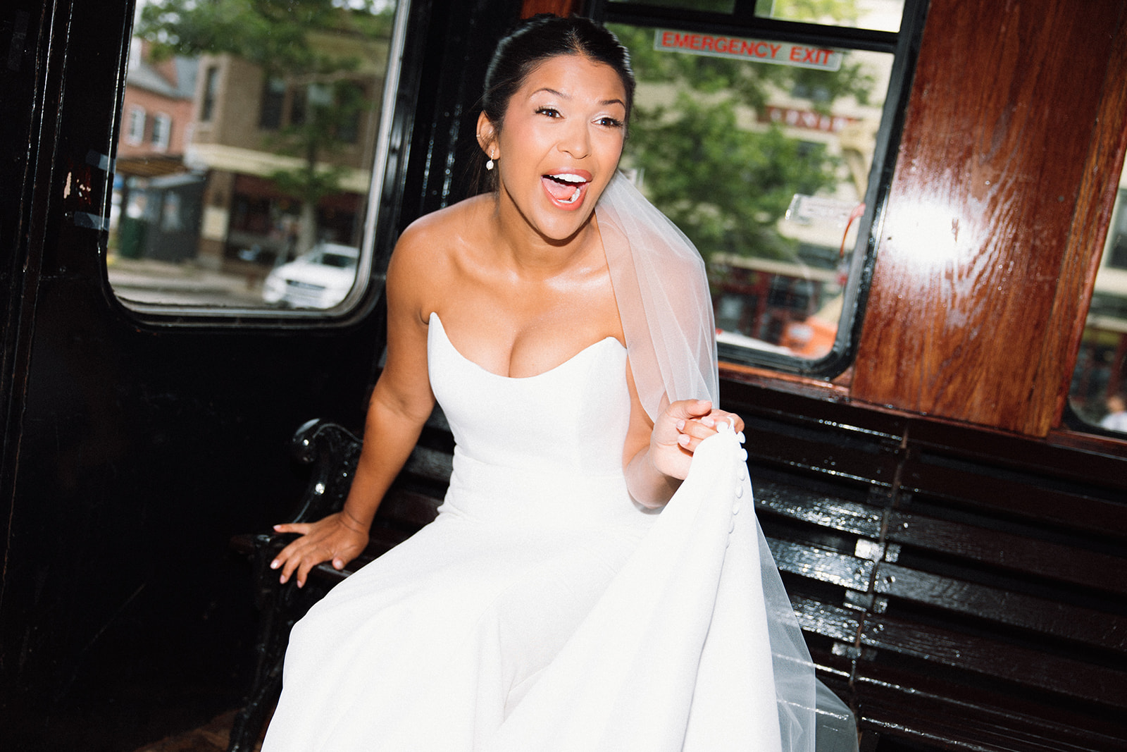 bride rides in trolley to wedding ceremony and laughs in salem massachusetts