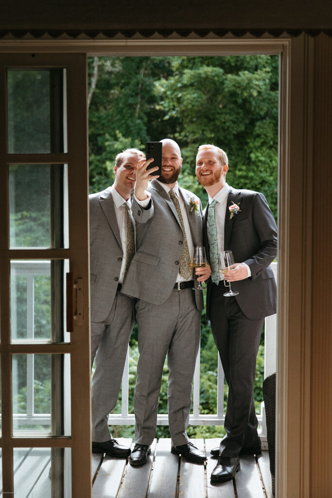 groomsmen take selfie before wedding ceremony at Bedford Village Inn