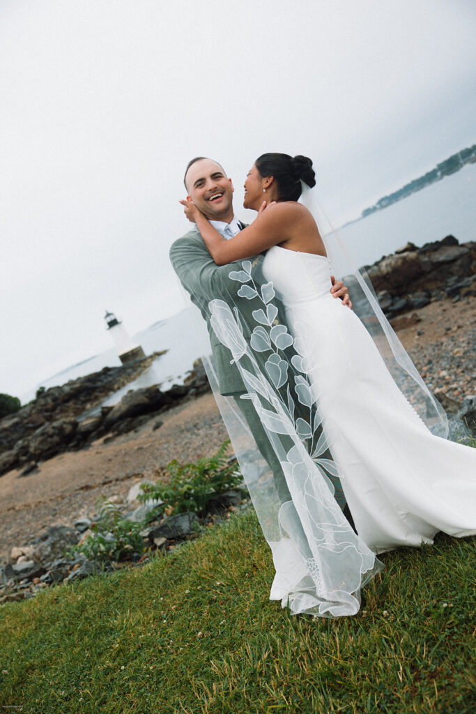 candid wedding portraits by the water with veil