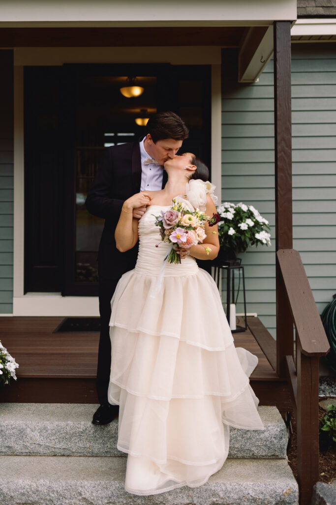 bride and groom kiss during wedding portraits at backyard wedding in new hampshire