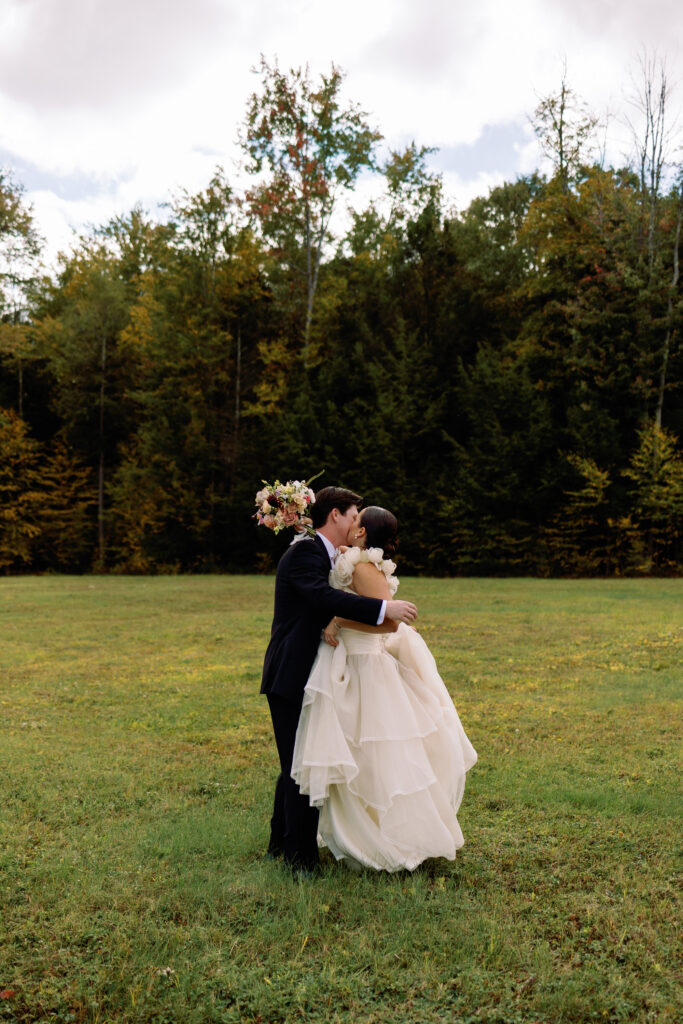 emotional photo of bride and groom hugging in field