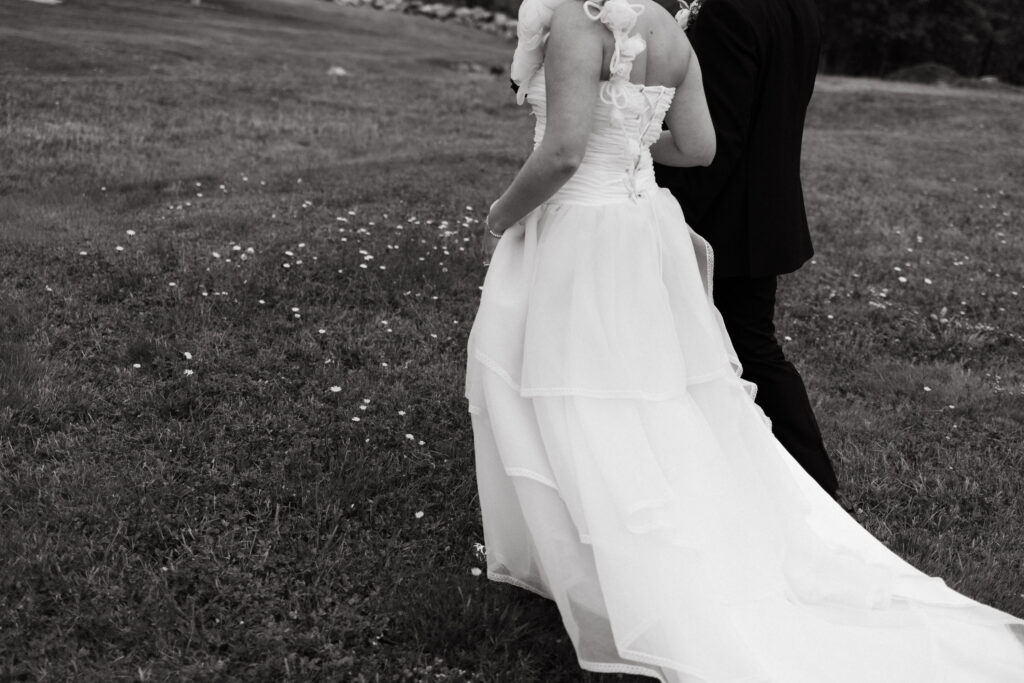 brides dress drags through field of wildflowers at intimate new hampshire wedding in september