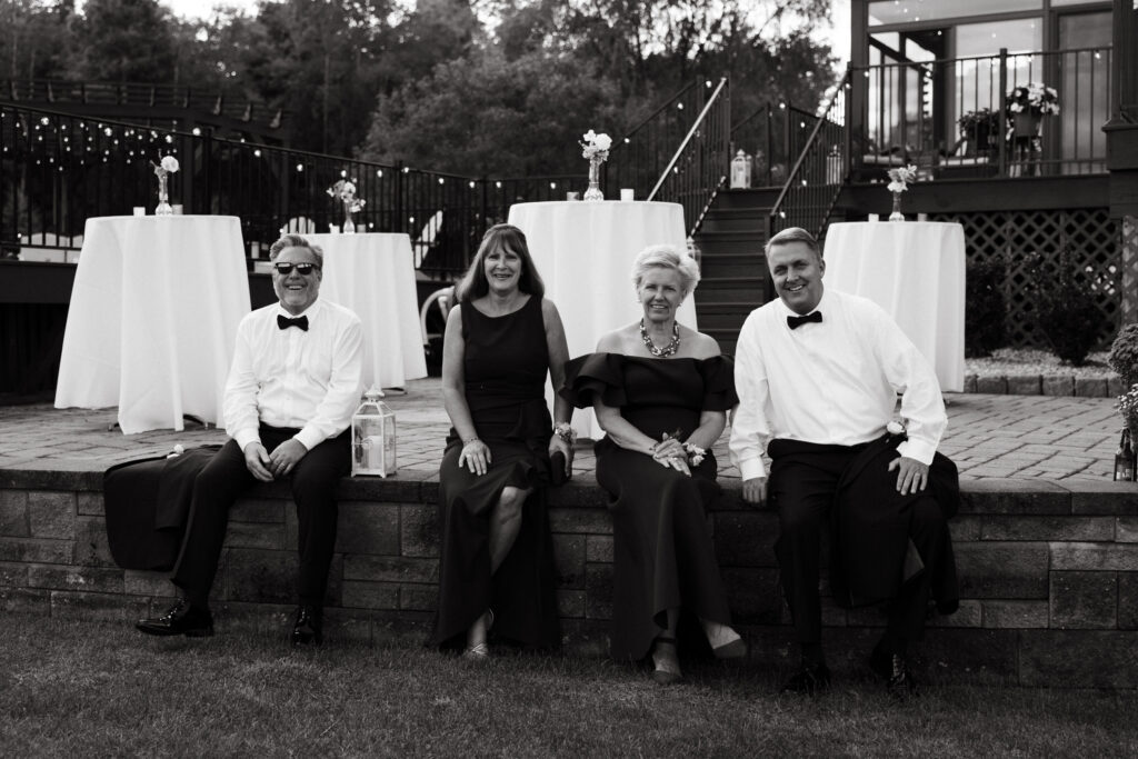 parents of the bride and groom hanging outside at backyard wedding in New England