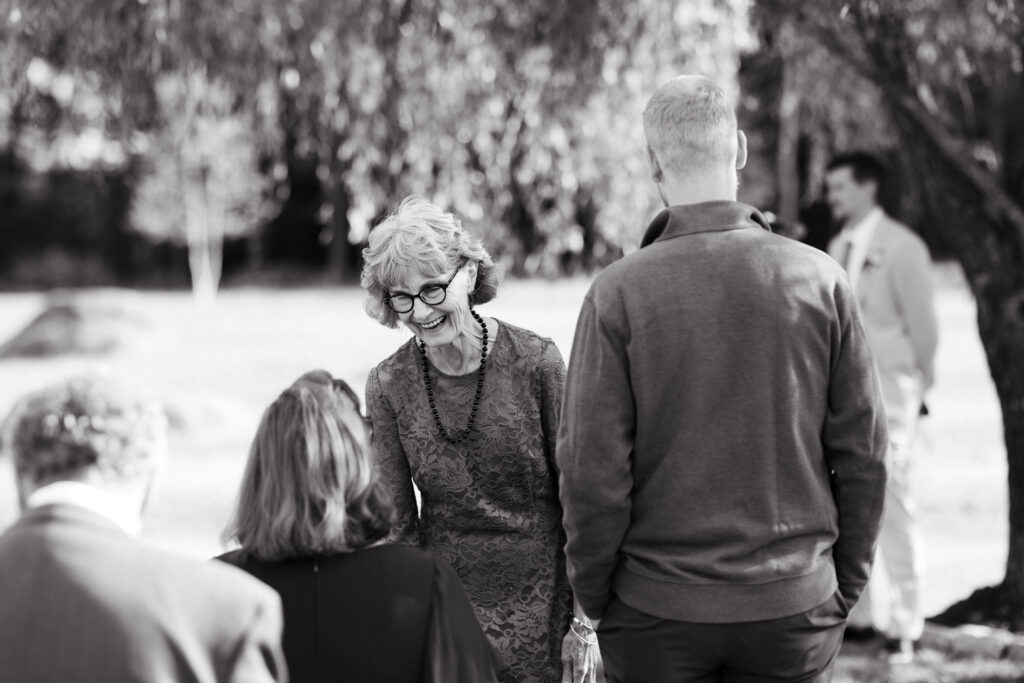 candid black and white photo of guests seeing each other for the first time