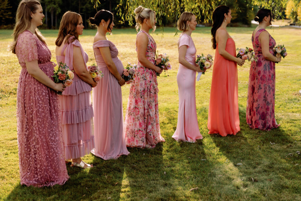 bridesmaids wearing shades of pink bridesmaids dresses