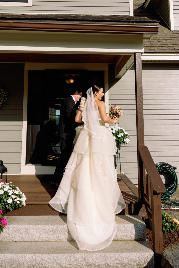 bride and groom exit wedding ceremony and her vintage wedding gown drapes down the stairs