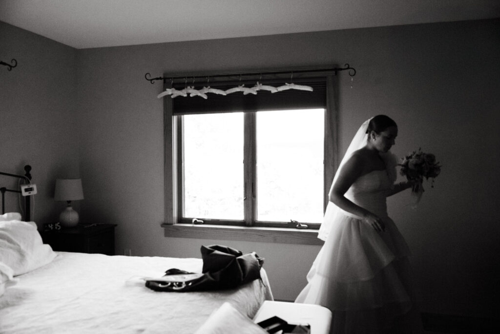 candid film wedding photo of bride in front of window