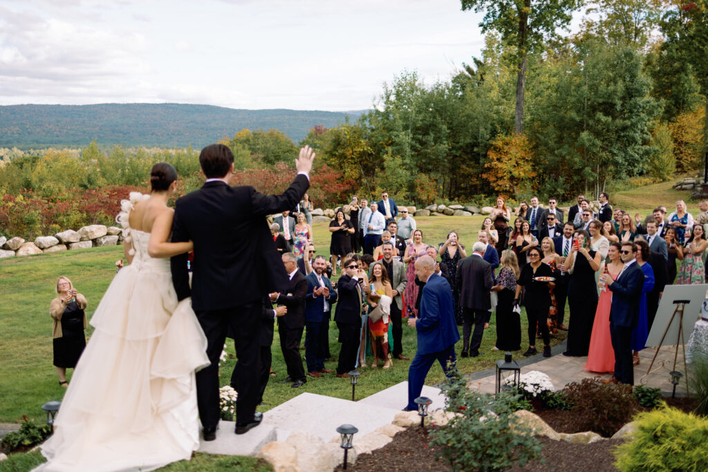bride and groom enter cocktail hour while everyone cheers