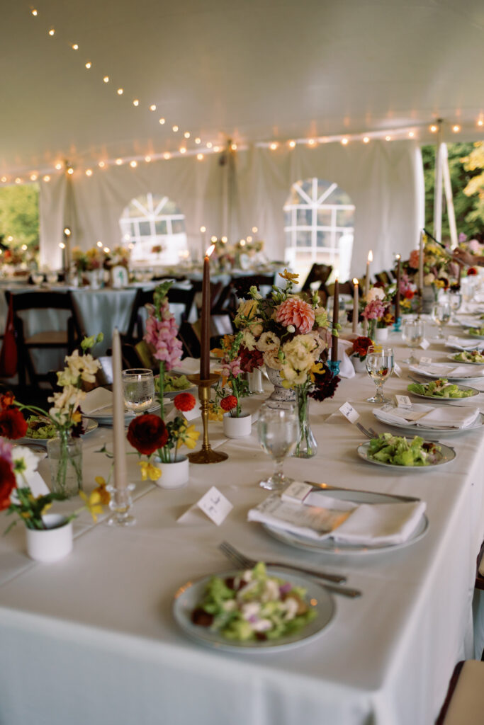 colorful floral centerpieces and taper candles at fall wedding reception