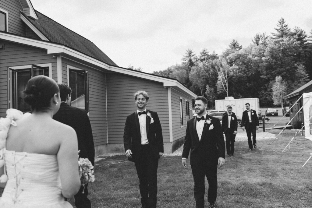 candid wedding photos of groomsmen seeing the bride and groom