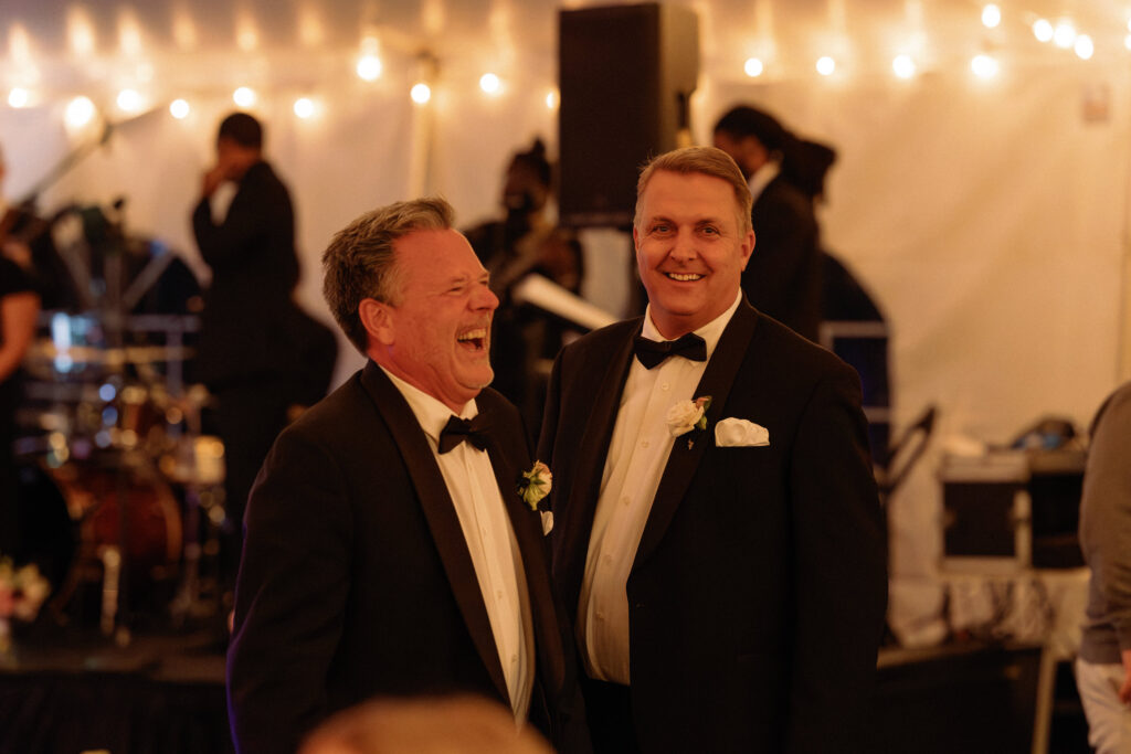 guests laughing during tent wedding reception