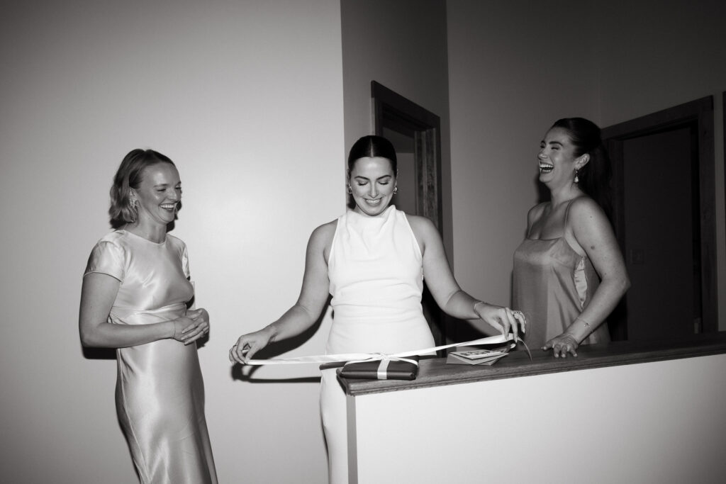 bride opens gift from friends