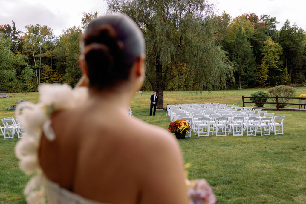 bride and groom do their first look down their wedding aisle