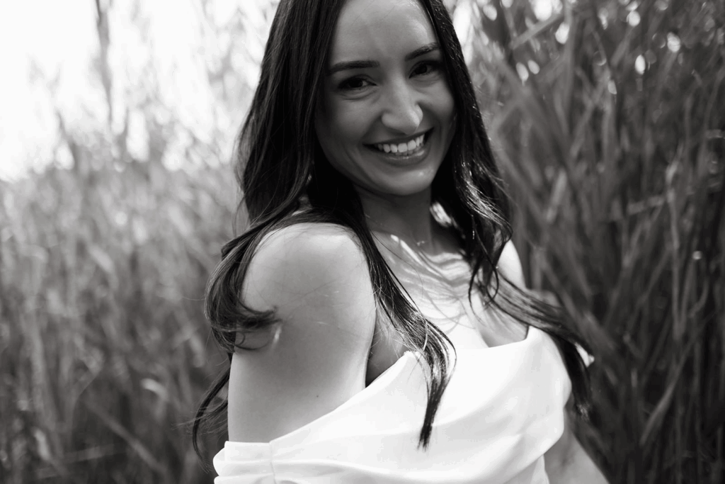 A bride smiling at the camera. 
