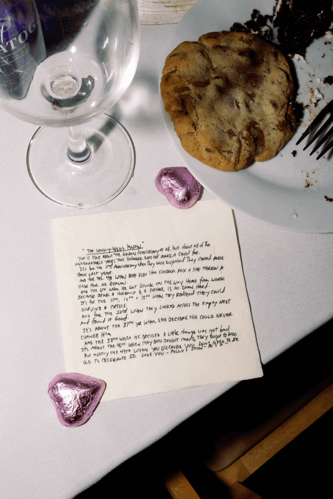 A napkin featuring a poem written by the father of the bride with food from the wedding around.