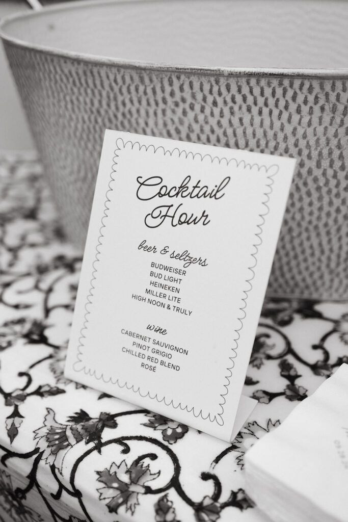 Wedding cocktail hour menu set on top of a table.