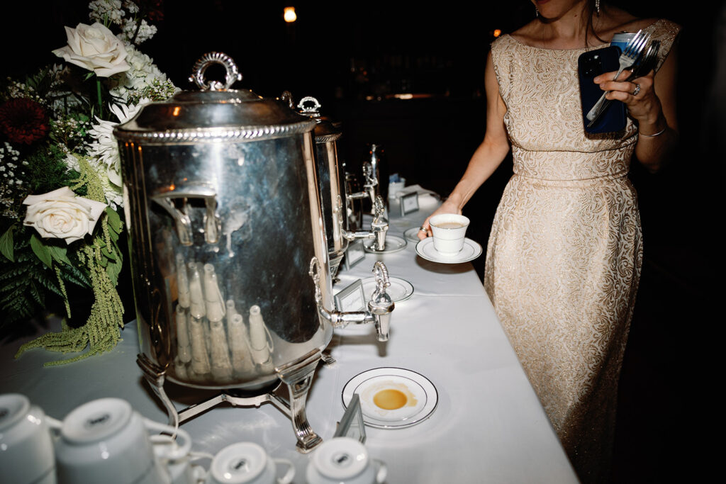 direct flash wedding photo of guest grabbing coffee from late-night coffee station