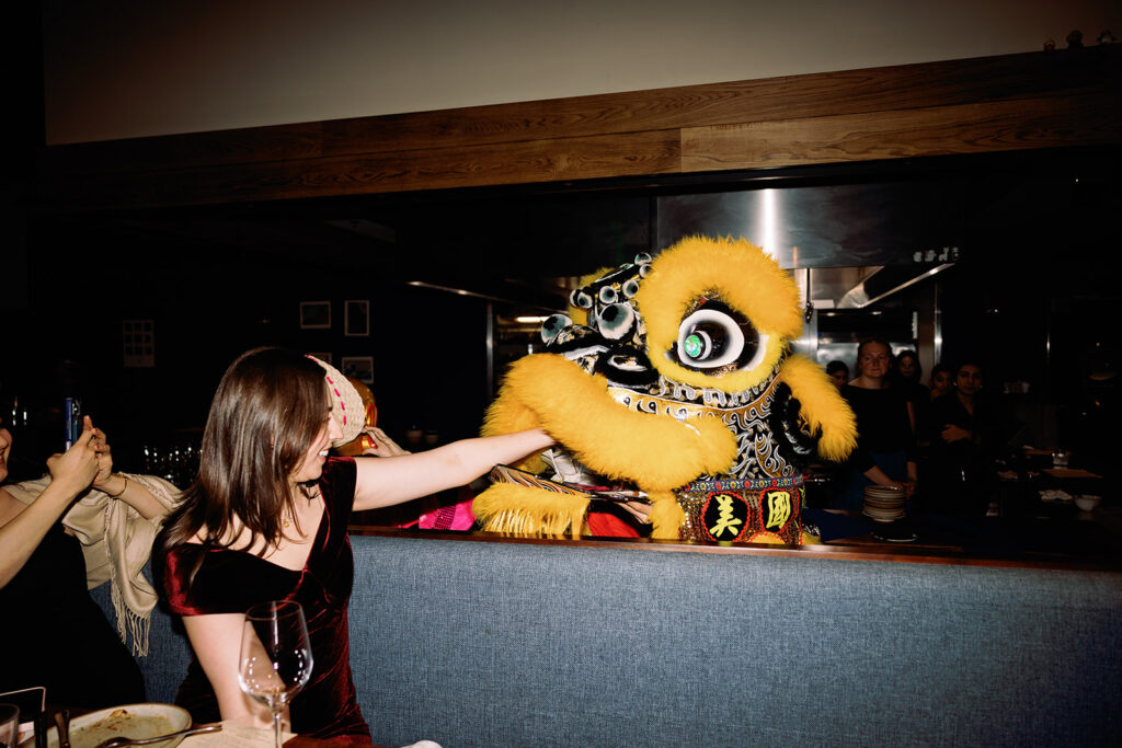 guests feed the lion dancers at PAGU wedding in Cambridge MA 