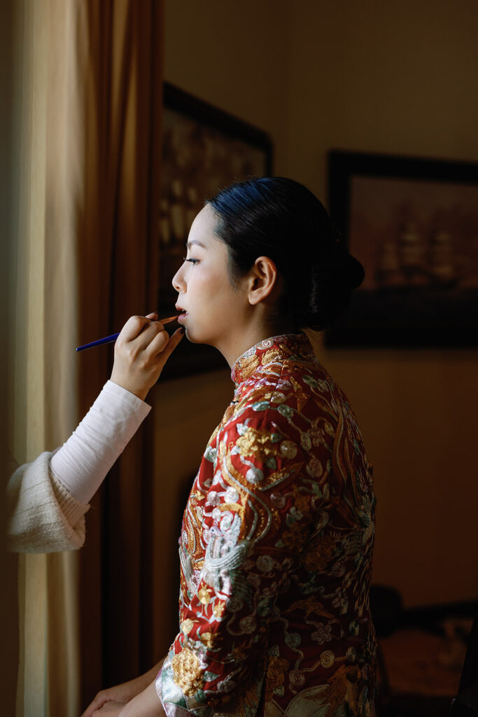 bride gets into traditional tea ceremony attire for her Cambridge MA tea ceremony at Le Meridien