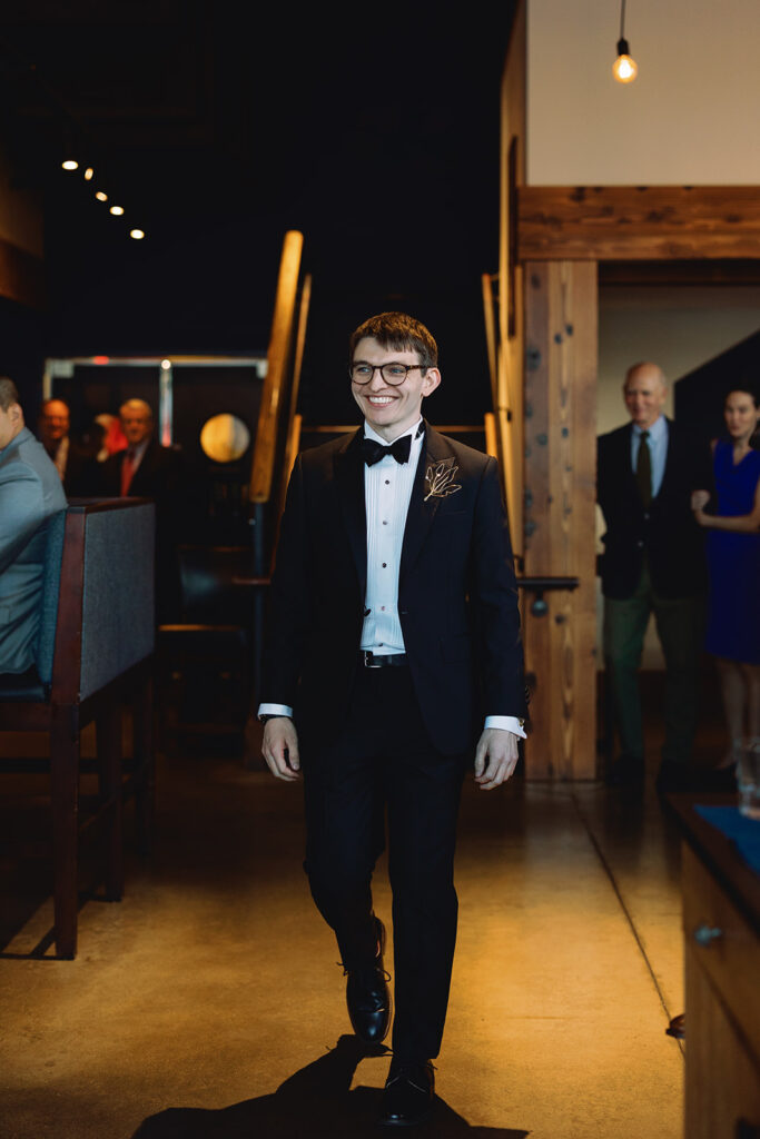 groom enters wedding ceremony at PAGU wedding in Cambridge 
