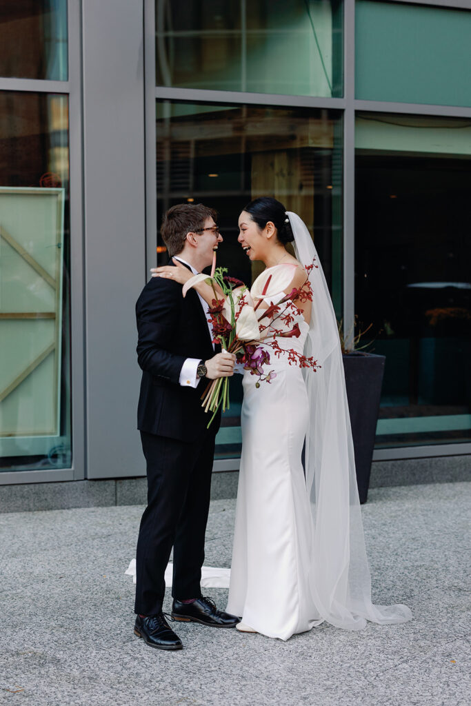 bride and groom excited after wedding ceremony at PAGU wedding in Cambridge 