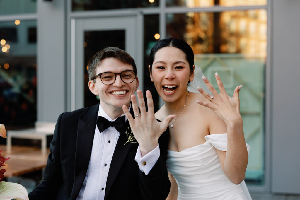 bride and groom flash their wedding rings after wedding ceremony at PAGU wedding