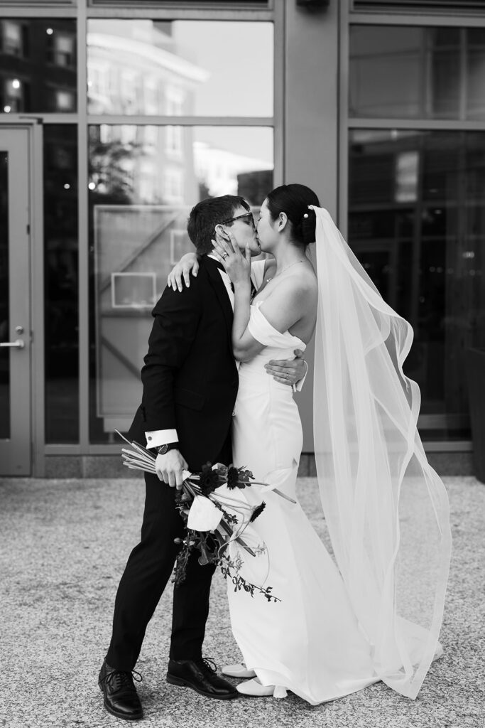 bride and groom kiss and celebrate their marriage after wedding ceremony at PAGU in Cambridge MA