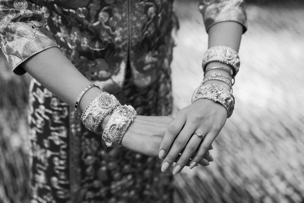 bride displays her gold bangles she received at her tea ceremony