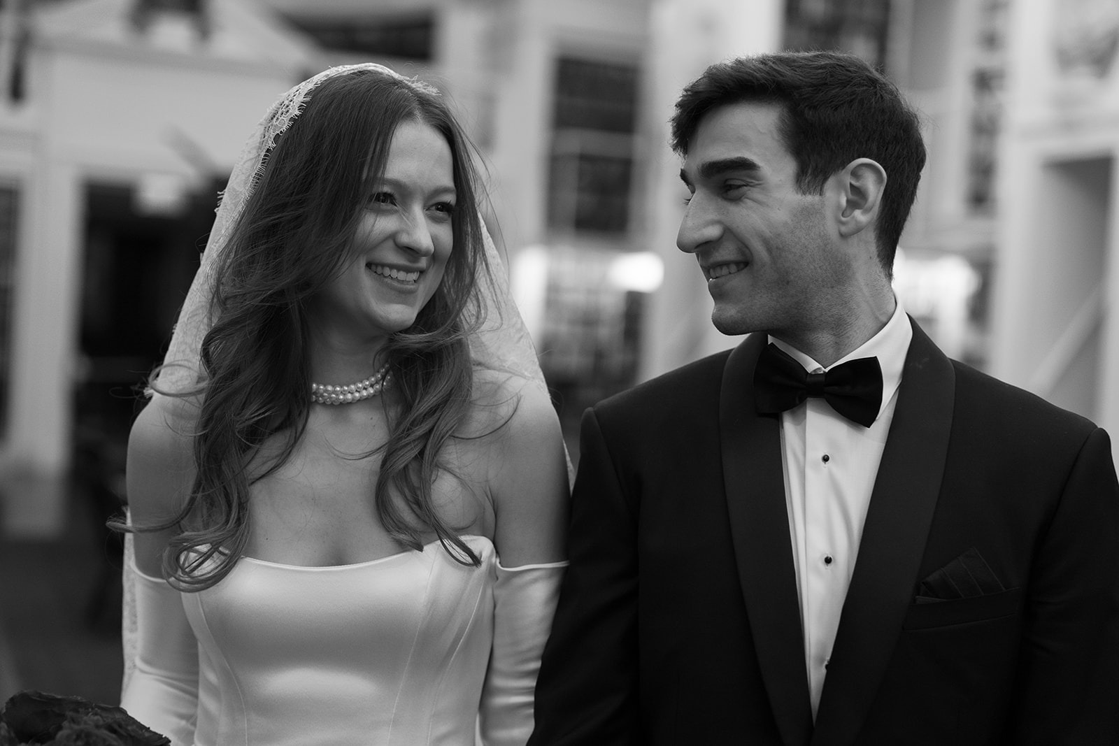 the bride and groom looking at each other at their athenaeum boston wedding