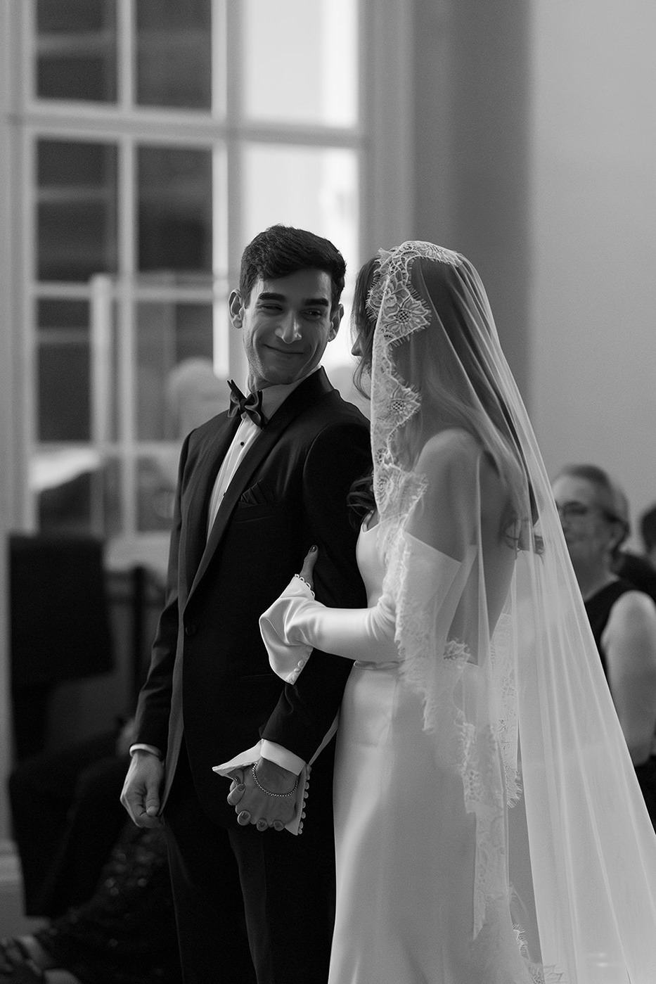 the bride and groom looking at each other at their boston athenaeum wedding