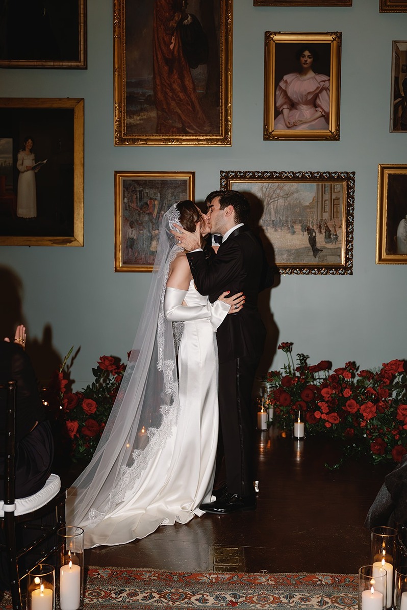 the bride and groom kissing at their boston athenaeum wedding