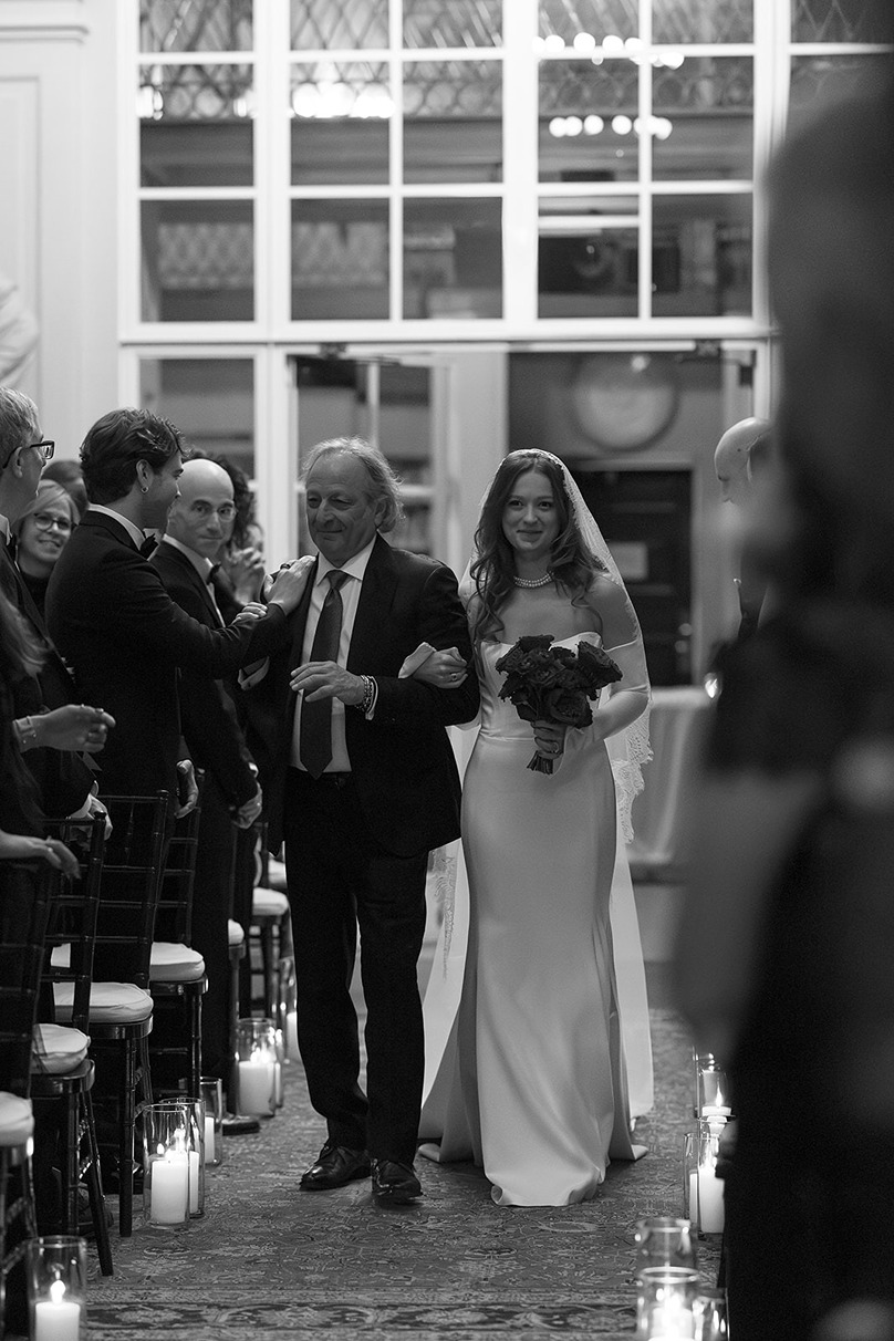 the bride and her dad walking down the aisle at a boston athenaeum wedding