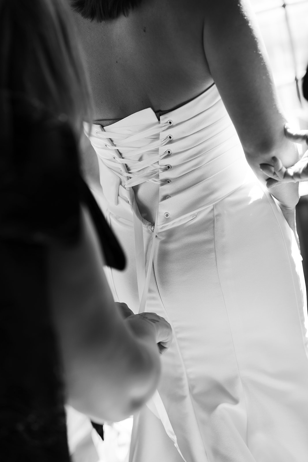 the bride putting on her dress at her turner hill wedding