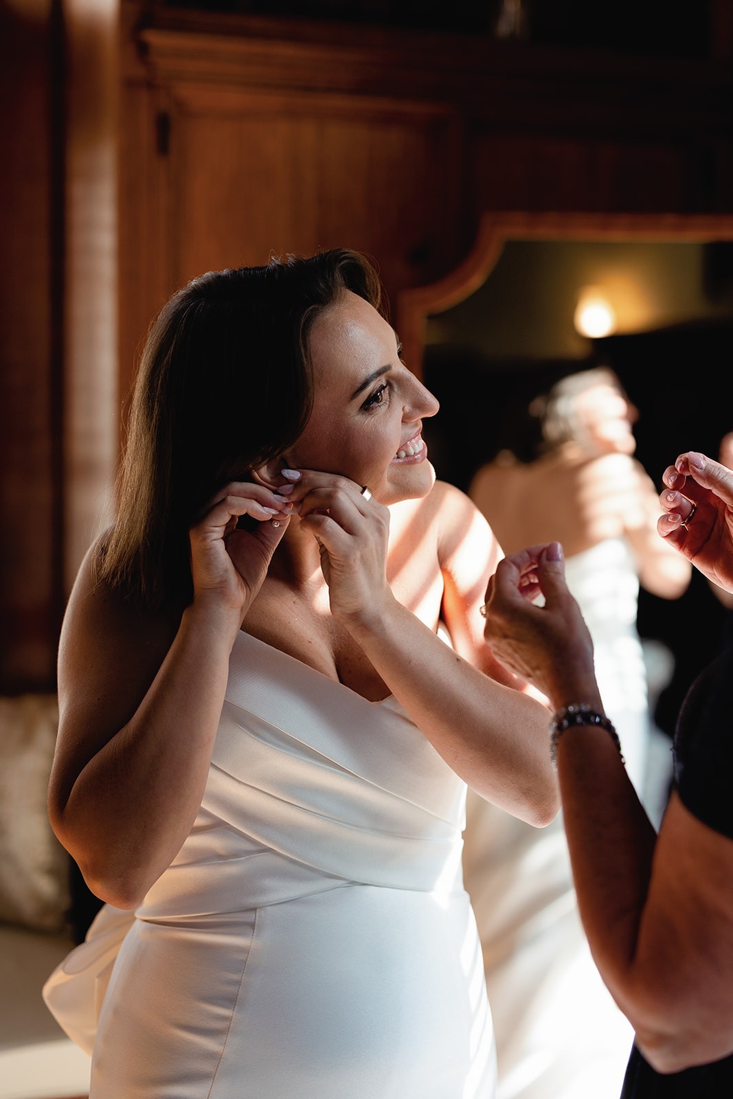 the bride putting on her earrings at her turner hill wedding