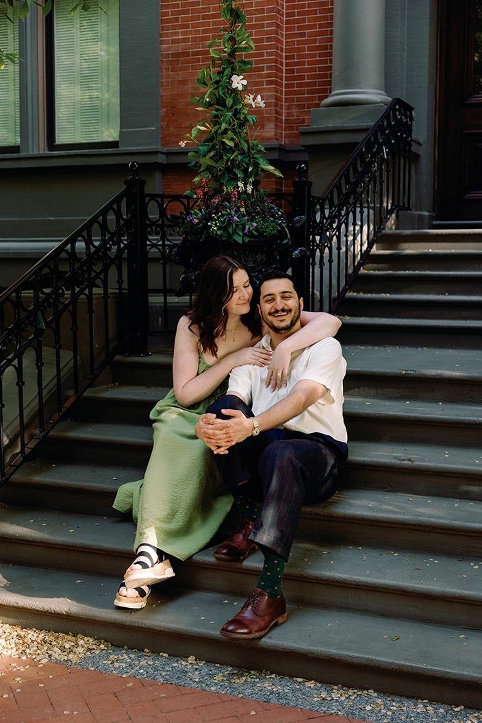a couple sitting on the stairs before they go to the boston common gazebo