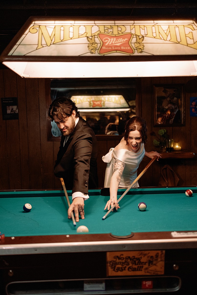 the bride and groom playing pool at a  boston restaurant wedding venues