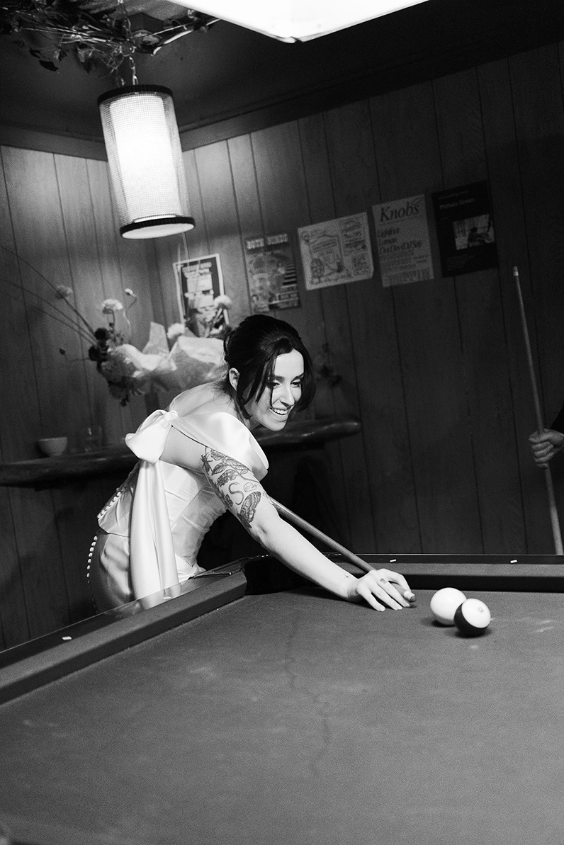 bride playing pool at a boston restaurant wedding venues