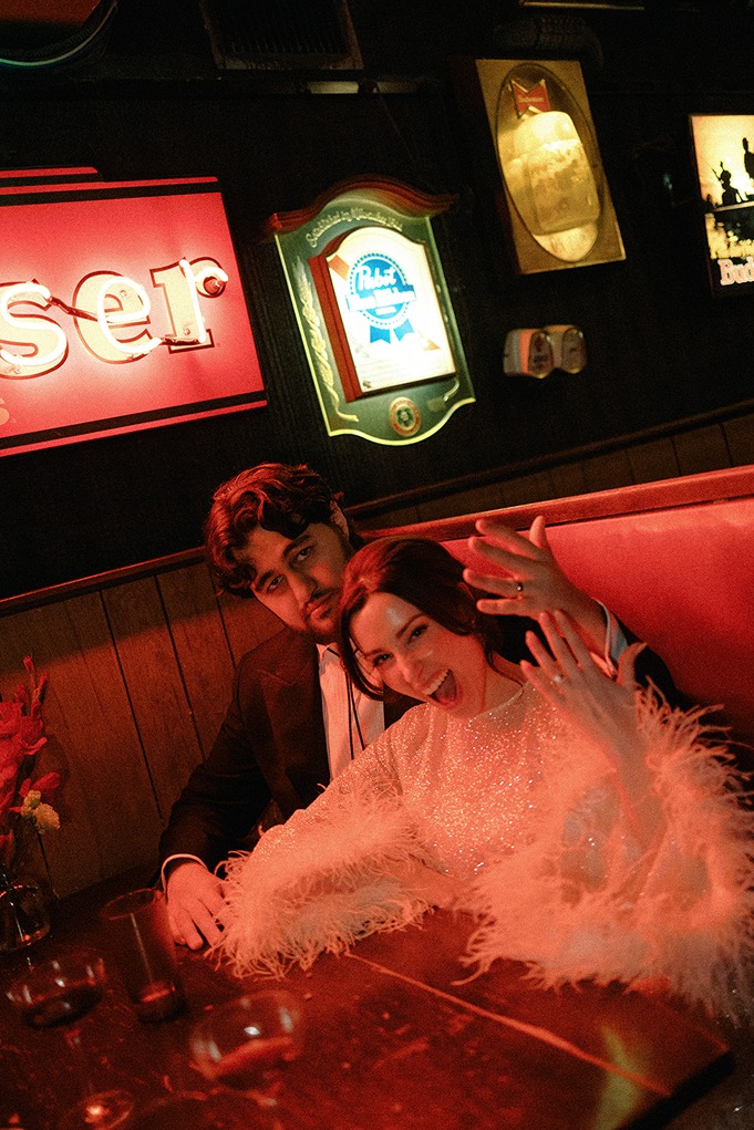 the bride and groom showing off their rings at a boston restaurant wedding venues
