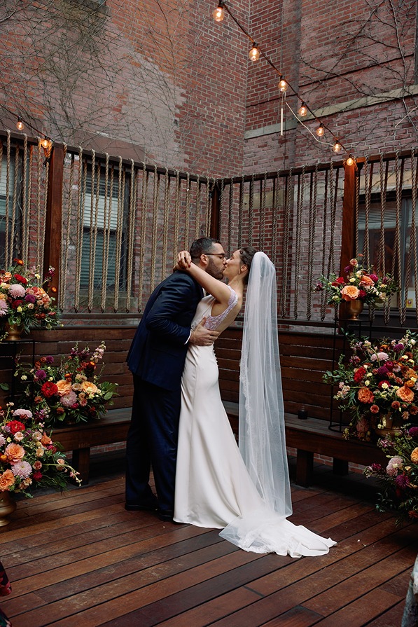 the couple kissing at their restaurant wedding venue in boston