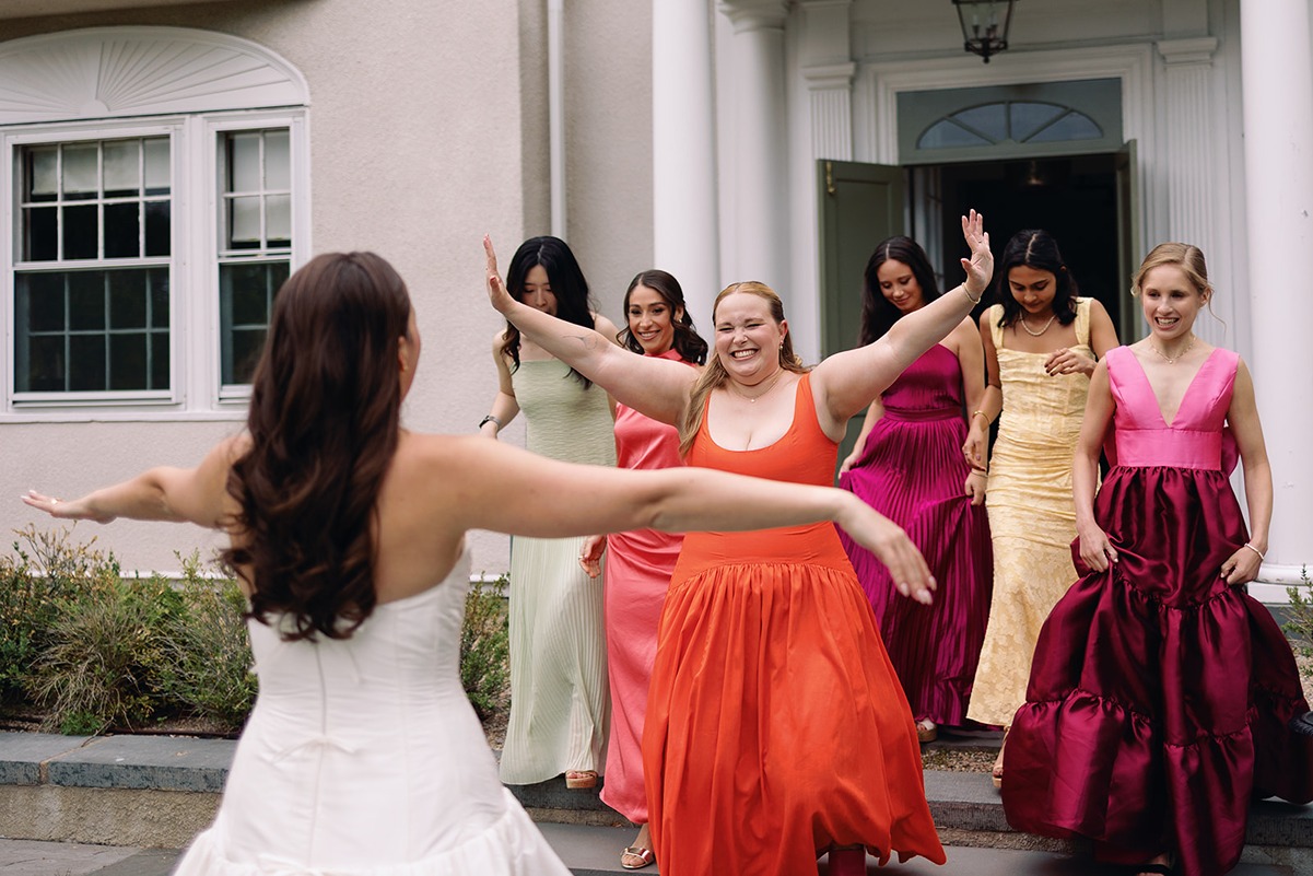 the bridesmaids greeting the bride at their garden at elm bank wedding