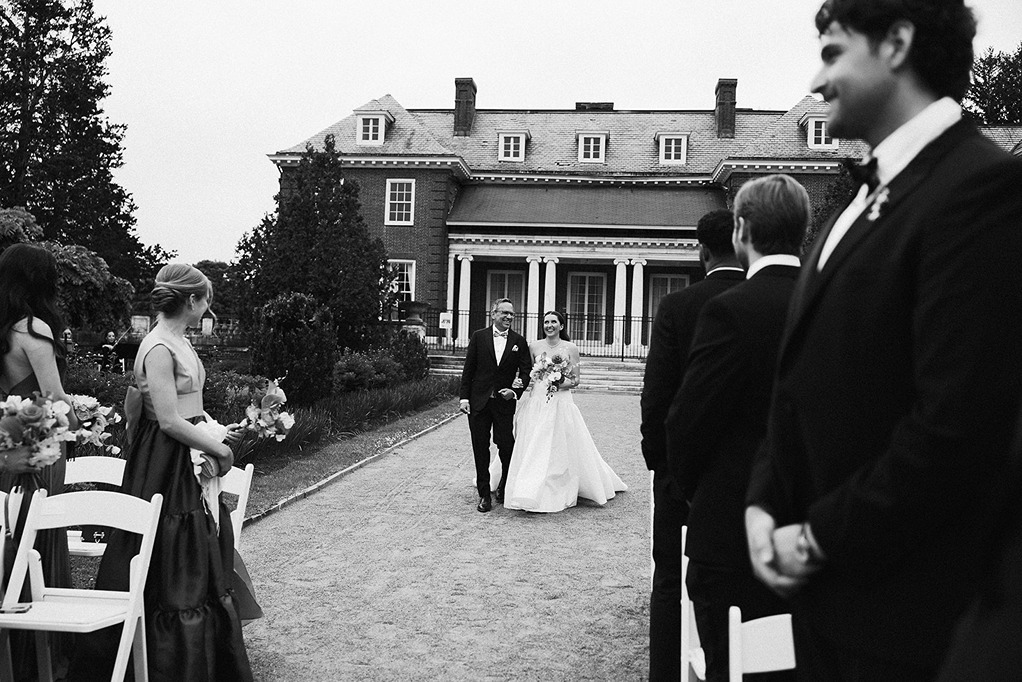 the bride walking down the aisle at her garden at elm bank wedding